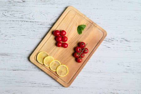 Tomatoes, basil and spices on wooden table. Cooking concept. Top view with space for your text.の写真素材