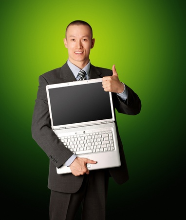 businessman in expensive suit with open laptop shows welldoneの写真素材