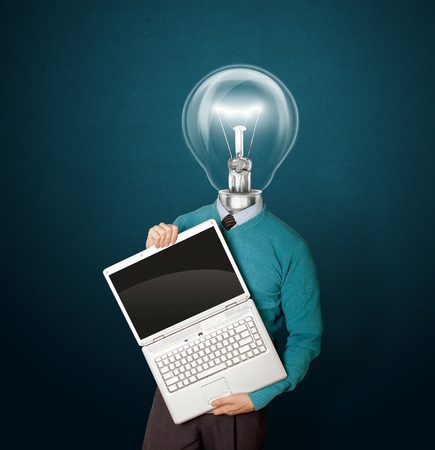 Male with lamp-head in blue, with open laptop in his handsの写真素材