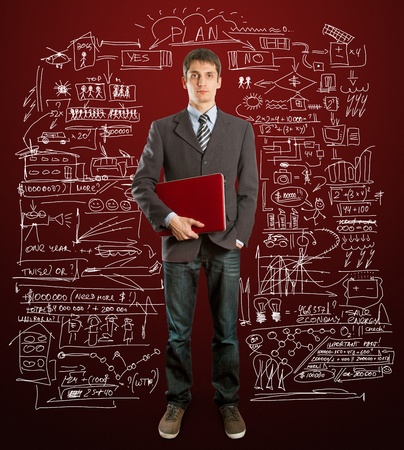 male businessman in suit with laptop in his hands, looking on cameraの写真素材