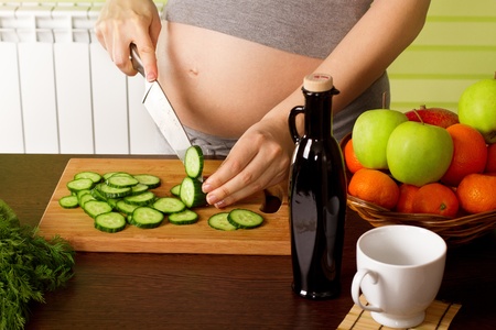 beautiful pregnant woman on kitchen with healthy foodの写真素材