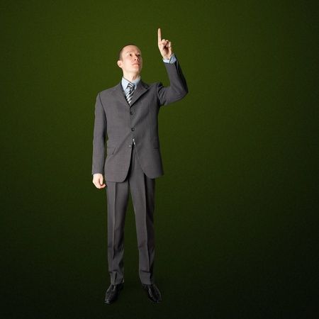 full length asian businessman push the button on virtual touch padの写真素材