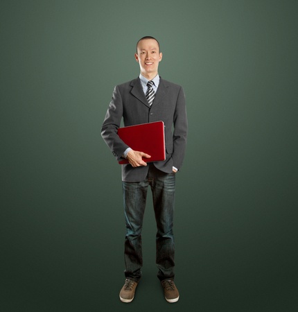 male businessman in suit with laptop in his hands, looking on cameraの写真素材
