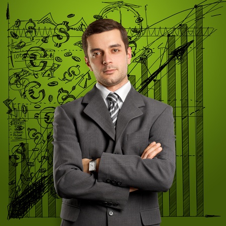 man businessman in suit, looking on camera, with folded handsの写真素材