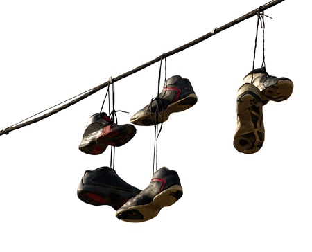 Sneakers hanging on a telephone line, urban youth jokeの写真素材