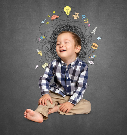 Little boy thinking about the childrens stuffの写真素材