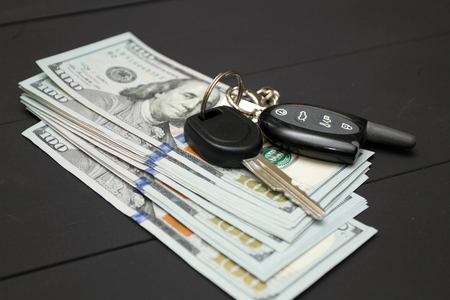 Dollars money cash on black background. Heap of money and car keyの写真素材