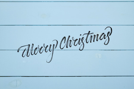 Close up of Wall Made of Wooden Planks. Blue Wooden Boards With Texture as Background. With Lettering Merry Christmasの写真素材