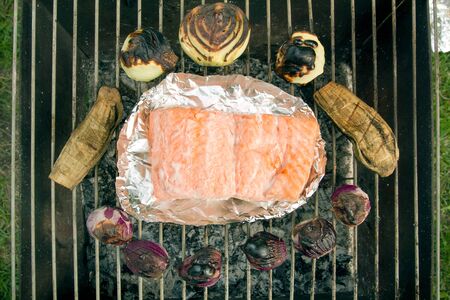 Fish On Barbecue Rack. Picnic. Grilling Outdoors At Summer Weekend. Barbecued Fresh Salmon With Trout And Onionの写真素材