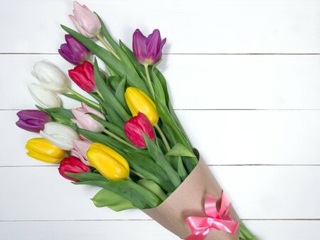 A bouquet of color tulips on the floor. A gift to a women day. Spring tulips flowers backgroundの写真素材