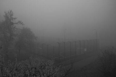 Mist cold autumn morning. Wet morning outdoors view from the window