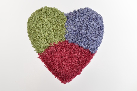 Three color  herbal rice in heart shapeの写真素材