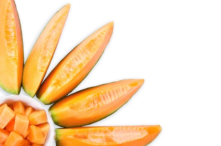 Cantaloupe melon slices in sun flower shape over white backgroundの写真素材