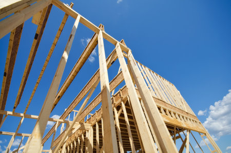 New residential construction home framing against blue skyのeditorial素材