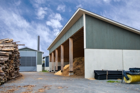 Piles of logs and wood chips waiting to be turned into biofuel for heating の写真素材