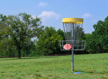 Disc golf hole basket in a parkの写真素材