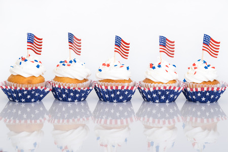 Row of patriotic 4th of July cupcakes with sprinkles and American flagsの写真素材