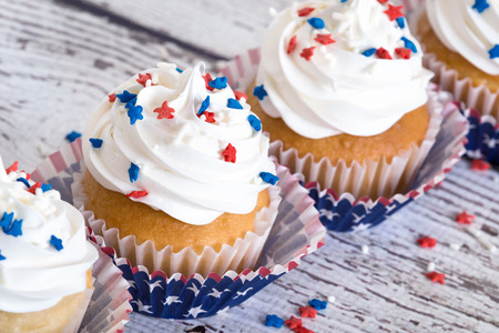 Cupcakes with patriotic 4th of July sprinkles on vintage background shallow depth of fieldの写真素材