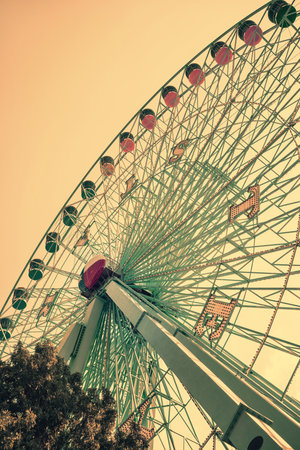 DALLAS, TX, - August 16, 2015: Texas Star, the largest ferris wheel in North America, rises above the horizon at Fair Park in Dallas, Texas. Vintage filter effects.のeditorial素材