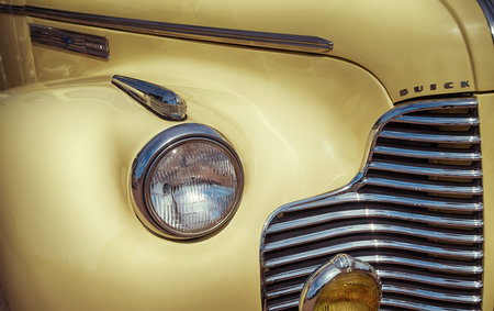 WESTLAKE, TEXAS - OCTOBER 17, 2015: Side view of a yellow 1940 Buick Special 46C Convertible classic car. Closeup of headlight details.のeditorial素材