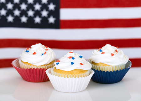 Patriotic cupcakes with American flag in the background.の写真素材