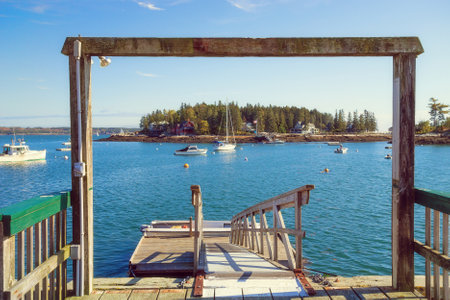 GEORGETOWN, MAINE - OCTOBER 14, 2017: A view from a fishing dock overlooking numerous boats moored in blue waters of picturesque Sheepscot Bay.のeditorial素材