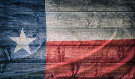 Texas state flag pattern on wooden board texture. Vintage style weathered background.の写真素材