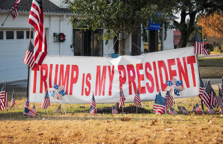 Texas, USA- December 11, 2020. Trump supporter sign and American flags displayed in the front yard of a Texas neighborhood after the election in December 2020.のeditorial素材