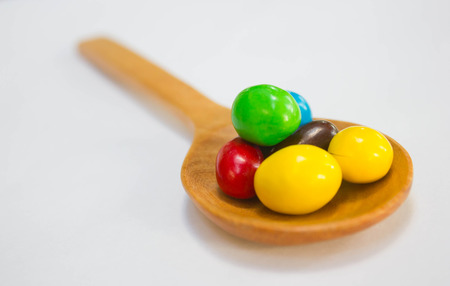 Colorful of Chocolate ball on wooden spoonの写真素材