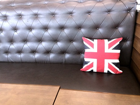 Red pillow on leather sofaの素材