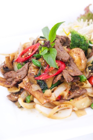 Stir fried flat rice noodles with basil sauce. の写真素材