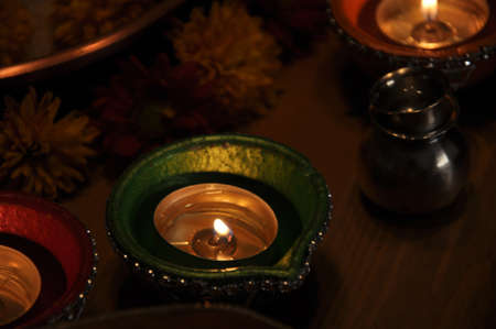 Diwali Lamp Fifteen - Beautiful, serene oil lamps shining in the calm of the night, surrounded by...