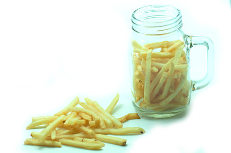 a pile of appetizing french fries on a white backgroundの写真素材