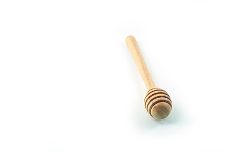 Honey dipper isolated placed on the white backgroundの写真素材