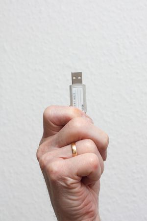 Senior holding a USB driveの写真素材