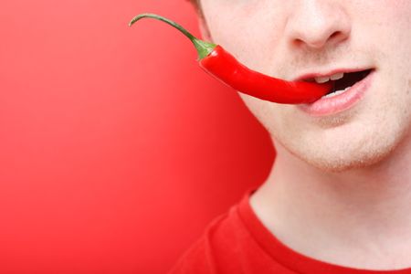 A man eating chili pepperの写真素材