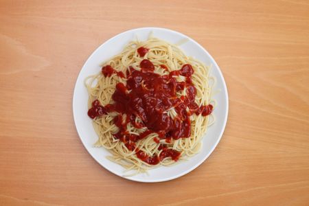 A boring plate of spaghetti with too much ketchupの写真素材