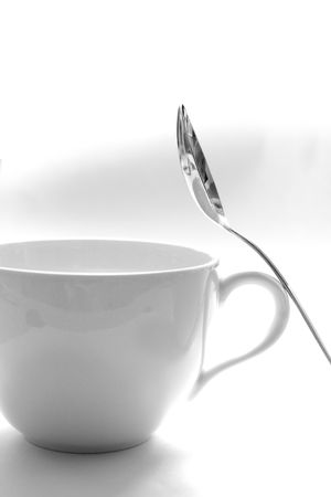 A cup and a spoon on a white backgroundの写真素材
