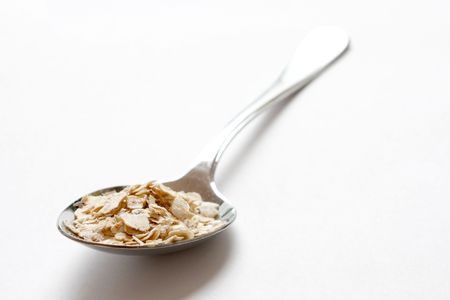 Oats in a heap isolated on whiteの写真素材