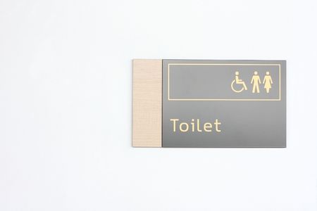A toilet sign on a wallの写真素材