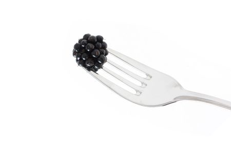Blackberries on a fork ready to eatの写真素材