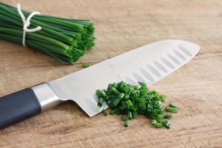 Chives on a wooden surfaceの写真素材