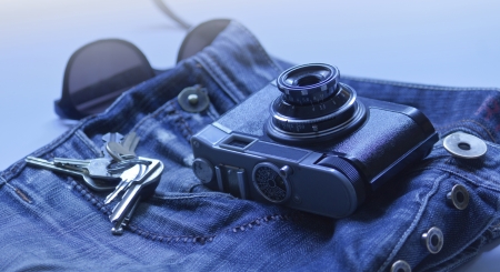 Vintage denim clothes of jeans and old camera