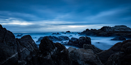 Moody dark sky over ominous rocksの写真素材