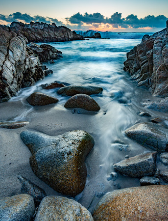 Wet rocks shine at sunsetの写真素材