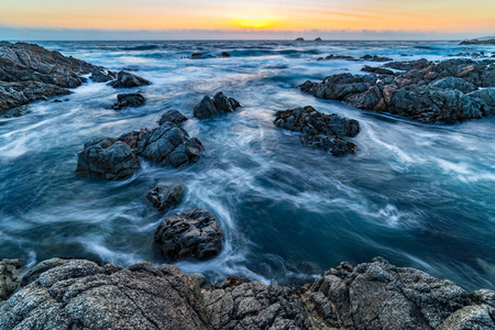 Turbulent water at sunsetの写真素材