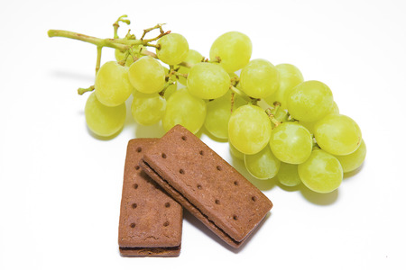 Green Grapes with Chocolate Biscuits on a White の写真素材
