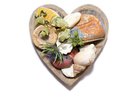 Wooden Heart with various array of Items on a White の写真素材