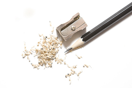 Pencil Sharpener alongside Pencil and Shavings on a White の写真素材
