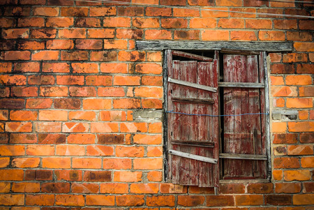 Wooden window on orange brick wallの写真素材